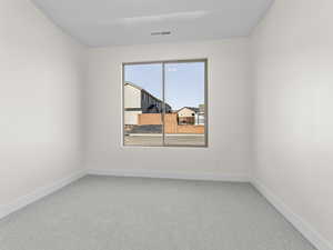 Unfurnished room featuring light colored carpet and baseboards