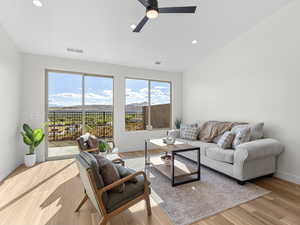 Living area featuring ceiling fan, lofted ceiling, light wood-style flooring, and recessed lighting