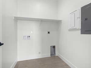Laundry area featuring hookup for a washing machine, electric panel, and hookup for an electric dryer