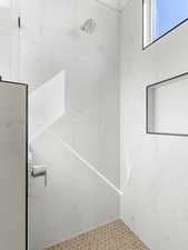 Full bath featuring a marble finish shower