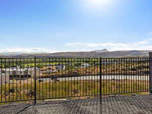 View of yard with a mountain view and a balcony