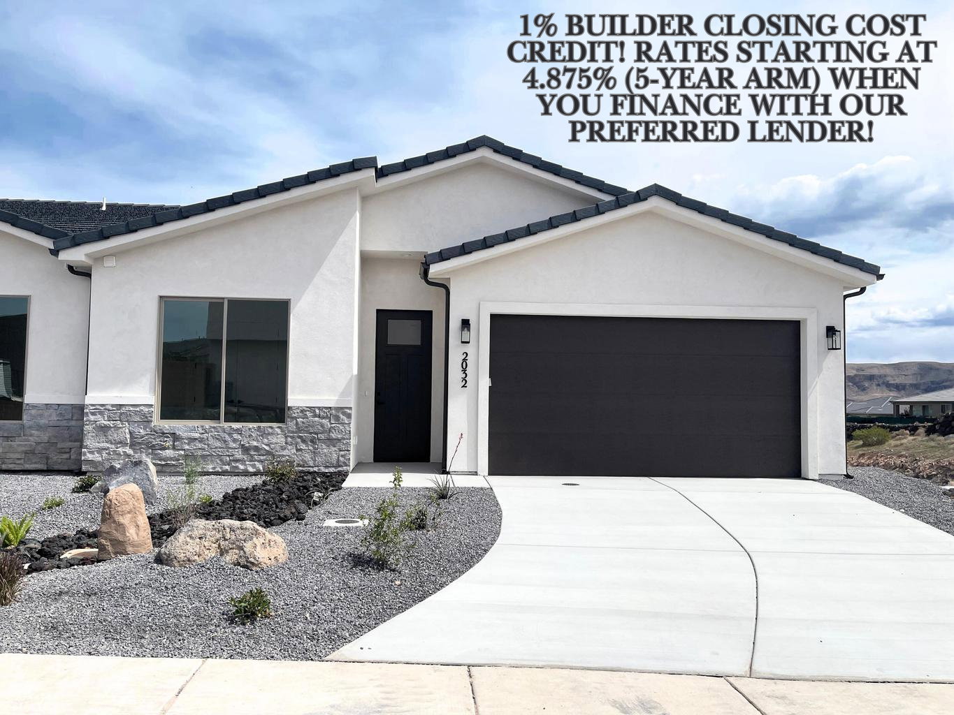 Contemporary single-story residence featuring a white stucco exterior and dark tile roof