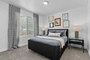 Carpeted bedroom featuring baseboards