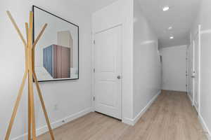 Corridor with recessed lighting and light wood finished floors