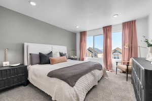 Bedroom featuring light colored carpet, recessed lighting, and a textured ceiling