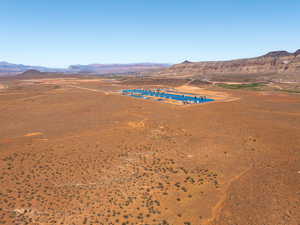 Aerial view of sparsely populated area featuring a mountain backdrop and a desert landscape