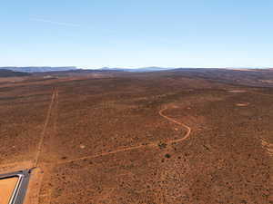 Aerial view of sparsely populated area featuring a mountain backdrop and a desert landscape