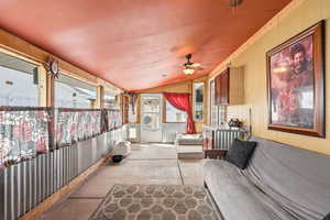 Sunroom / solarium with ceiling fan, lofted ceiling, and a patio area