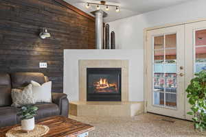 Carpeted living area featuring a fireplace