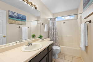 Bathroom with vanity, light tile patterned flooring, and shower / bath combo
