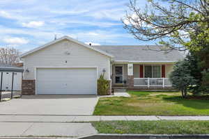 Single level Ranch-style house featuring covered porch, concrete driveway, a garage.