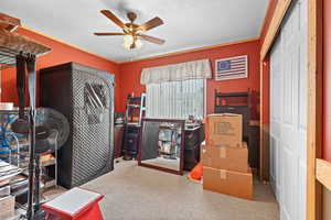 Home office featuring light carpet and ceiling fan