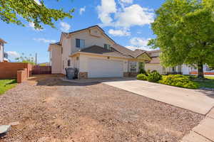 Traditional-style house with concrete driveway, brick siding, and a garage
