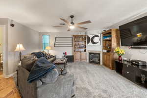Living room with a fireplace and a ceiling fan