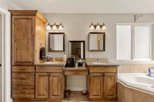 Primary bathroom with double vanity and a garden tub