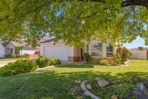 Obstructed view of property featuring brick siding and an attached garage