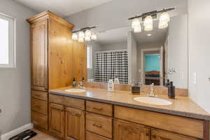 Bathroom featuring double vanity and a shower with curtain