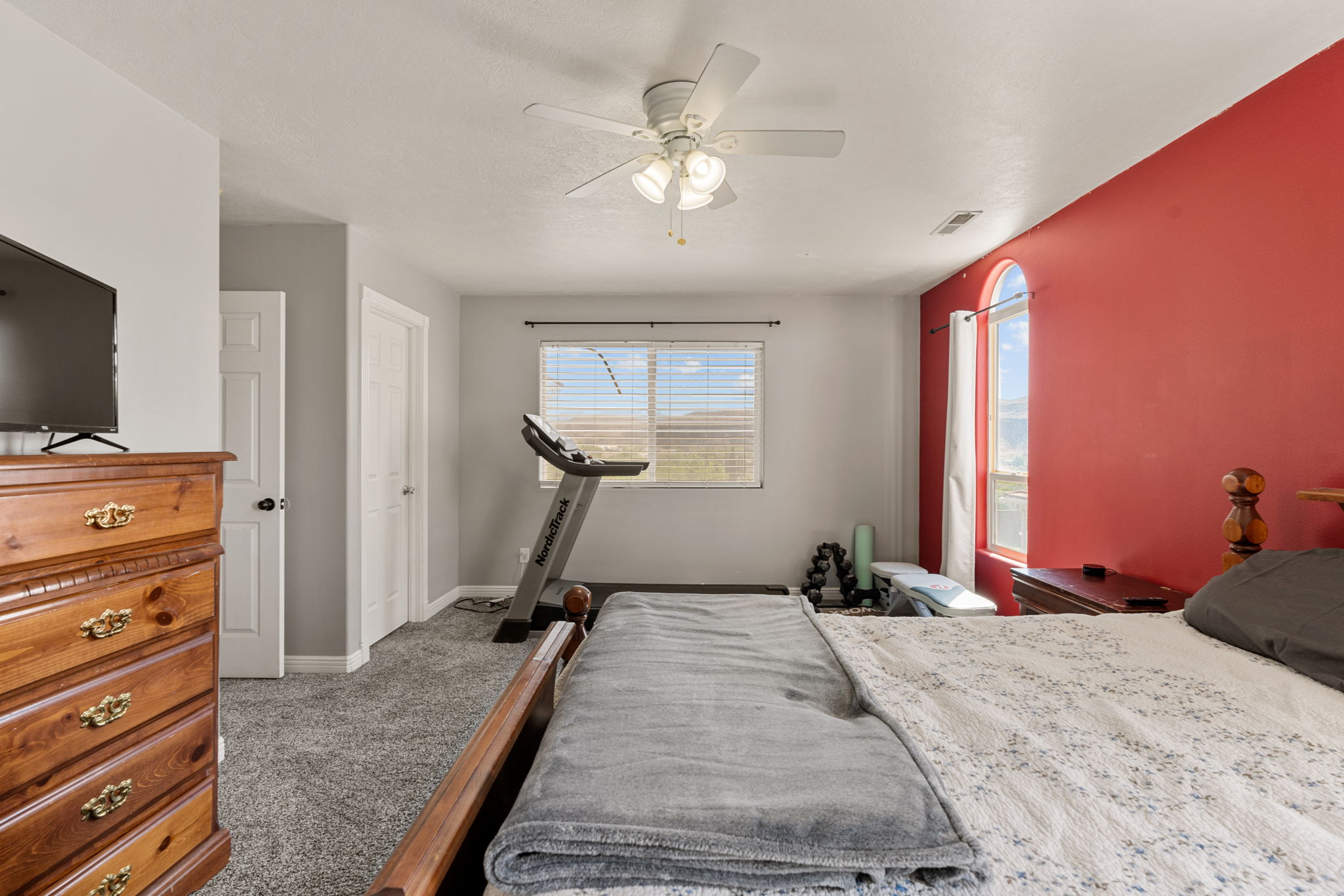 Bedroom with dark carpet and ceiling fan