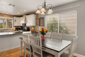 Dining space featuring a chandelier and light wood-type flooring