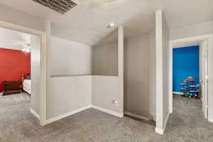 Bonus room featuring carpet and a ceiling fan