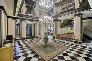Lobby with a decorative wall, crown molding, and a high ceiling