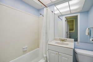 Full bathroom featuring vanity and shower / bathtub combination with curtain