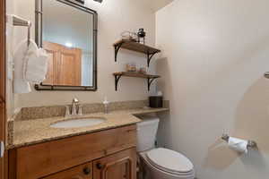 Bathroom with vanity and a textured wall