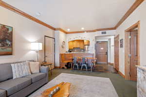 Living room featuring crown molding and recessed lighting