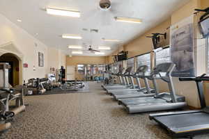 Exercise room featuring a textured ceiling and ceiling fan