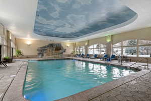 Indoor pool featuring a sunroom