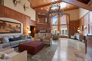 Common area featuring a high wood beamed ceiling, wooden walls, and recessed lighting