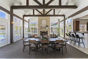 Dining space featuring french doors and a fireplace