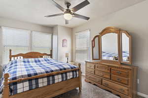 Bedroom with ceiling fan and carpet flooring