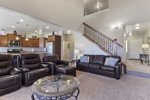 Living area featuring light colored carpet and recessed lighting