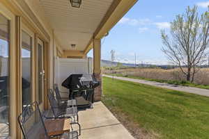 View of patio / terrace with area for grilling and a mountain view