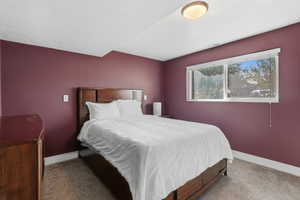 Bedroom with carpet floors and a textured ceiling