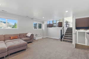 Living room with light colored carpet and recessed lighting