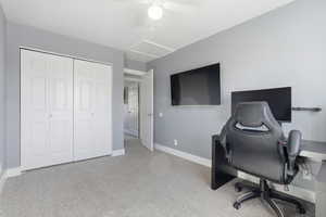 Office space with light carpet and a ceiling fan