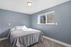 Carpeted bedroom with baseboards