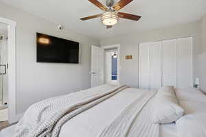Bedroom with a ceiling fan and a closet