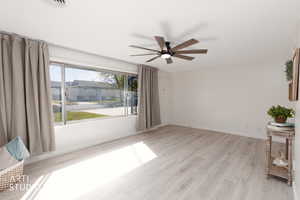 Living room with new LVP flooring and lighting with a big picture window.