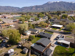 Aerial overview of property's location featuring nearby suburban area and a mountainous background