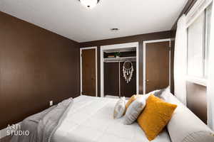 Bedroom featuring multiple closet