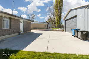View of  large open patio, RV pad and detached garage.