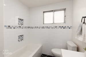 Bathroom featuring tile walls and vanity