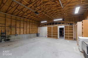 Garage featuring a garage door opener pleanty of stoprage space and room for multiple cars.