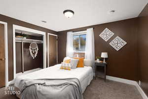 Bedroom with carpet floors and multiple closets
