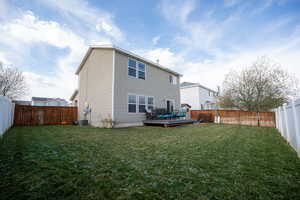 Back of house featuring a wooden deck and a fenced backyard