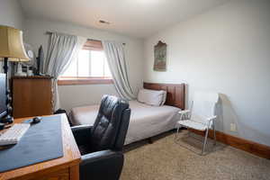 Bedroom with baseboards and a desk