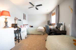Bedroom featuring light carpet and a ceiling fan